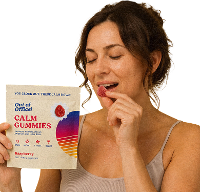 Woman eating an Out of Office Calm gummy and holding the pack