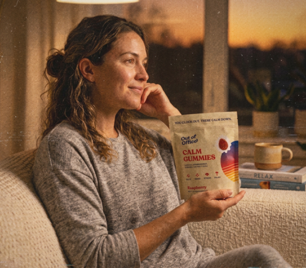 Woman relaxing with Out of Office Calm gummies at golden hour