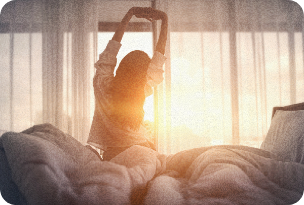 Person waking up rested at sunrise